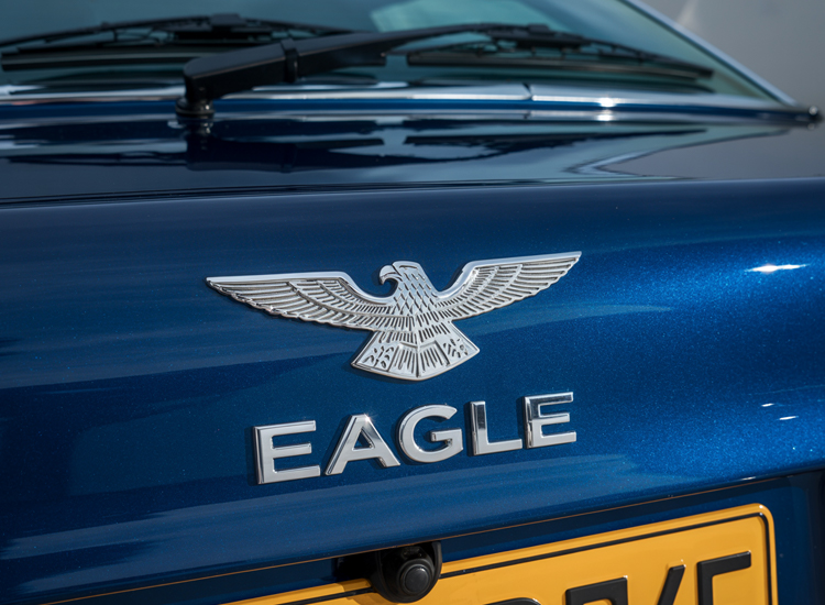 clean exterior car mods with lowered stance, custom wheels, and a subtle custom car emblem on the front