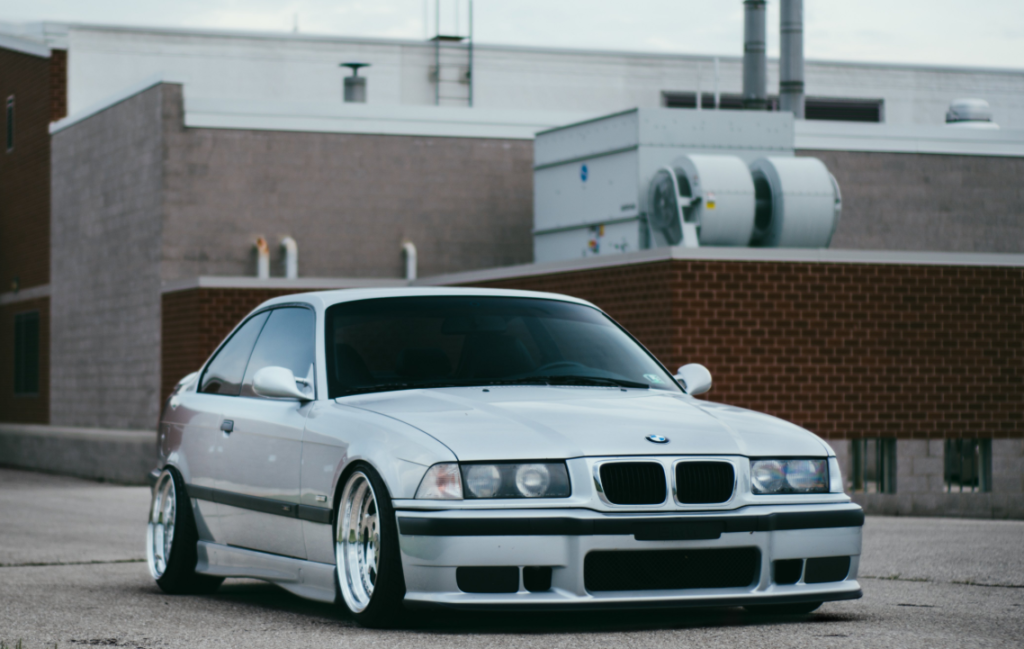 clean OEM plus exterior car mods with lowered stance, custom wheels, and subtle metal emblems